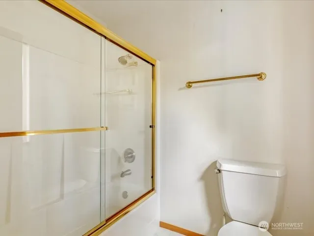 a bathroom with a shower and toilet