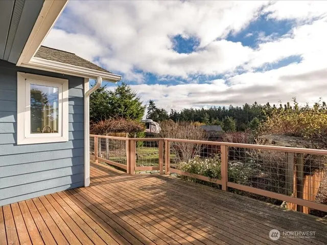 a view of a balcony with mountain view and wooden floor