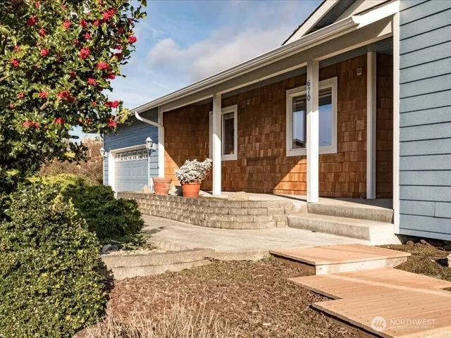 a view of a house with a snow on the side of the road