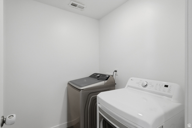1177 South Raintree Lane Santaquin, UT 84655 - Photo 11 of 25 Laundry area with white walls and modern appliances