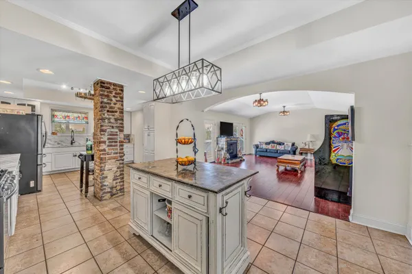 a kitchen with granite countertop a stove and cabinets