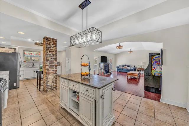 a kitchen with granite countertop a stove and cabinets