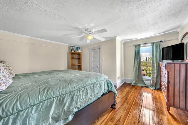 a bathroom with a granite countertop sink a toilet and shower