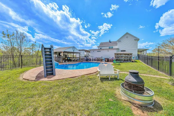 a view of a house with a porch and a yard