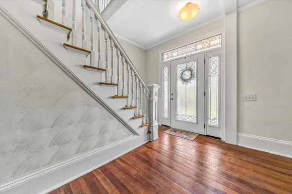 a view of a dining room with furniture and wooden floor