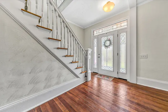 a view of a dining room with furniture and wooden floor