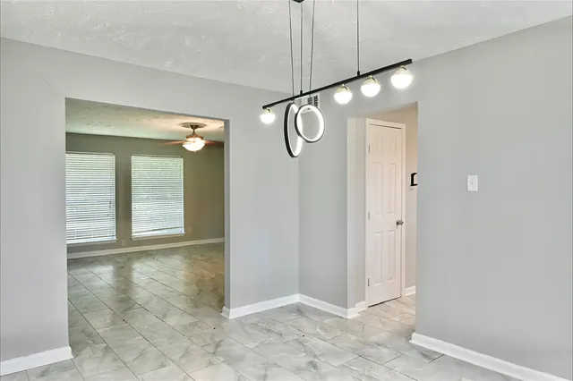 a view of a hallway with chandelier and entryway