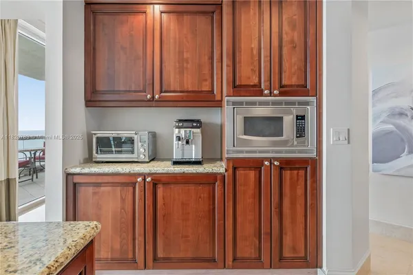 a kitchen with stainless steel appliances granite countertop a refrigerator and cabinets