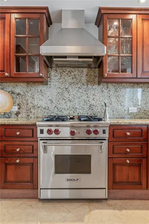 a kitchen with stainless steel appliances granite countertop a stove and a microwave