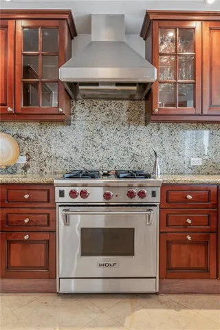 a kitchen with stainless steel appliances granite countertop a stove and a microwave