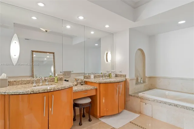 a bathroom with a granite countertop sink a toilet and a mirror