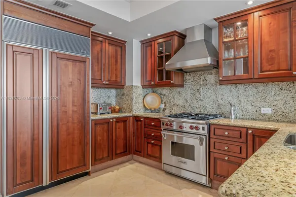 a kitchen with stainless steel appliances granite countertop a stove and a sink