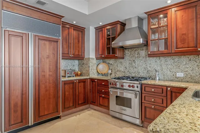 a kitchen with stainless steel appliances granite countertop a stove and a sink