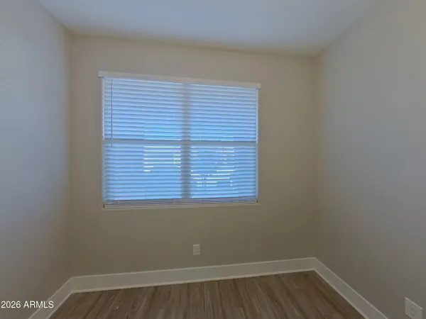 a view of a kitchen with a sink and wooden floor