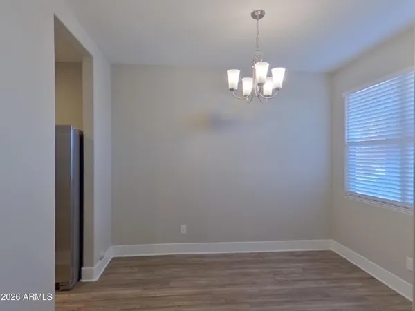 a view of a small space with wooden floor and a window