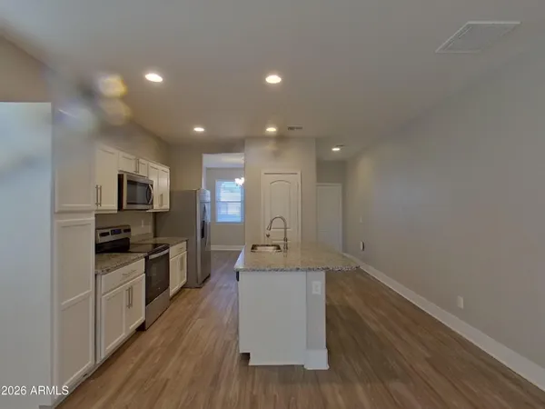a view of a chandelier fan and hardwood floor