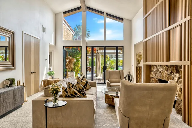 a kitchen with stainless steel appliances kitchen island granite countertop a table and chairs in it