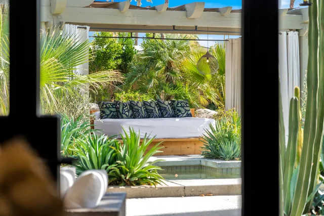 a view of a living room with a large window and chandelier