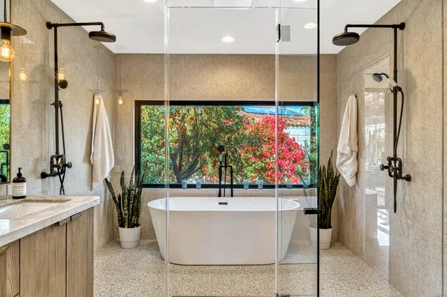 a living room with patio furniture and garden view