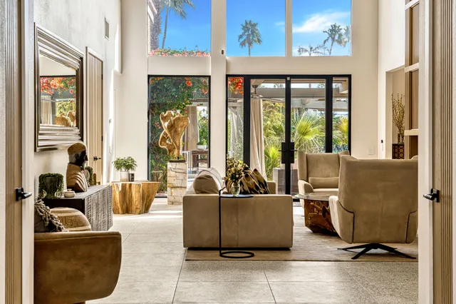 a living room with furniture gym equipment and a large window