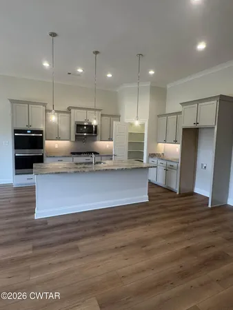 a view of kitchen with refrigerator stove and microwave