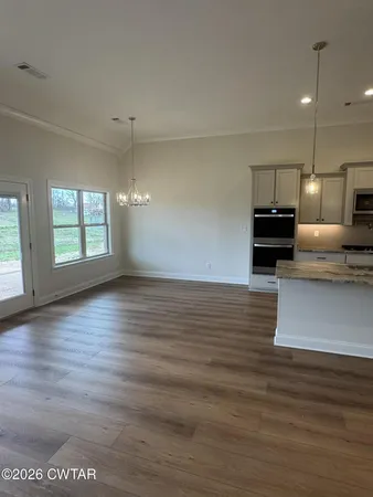 a view of kitchen with cabinets and wooden floor