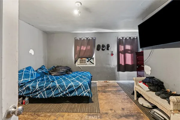 a bathroom with a toilet and a flat screen tv