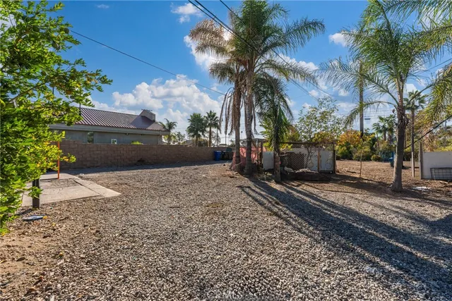 a view of a chairs and table in backyard