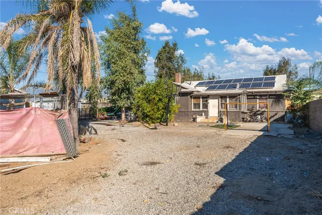 a front view of a house with table and chairs