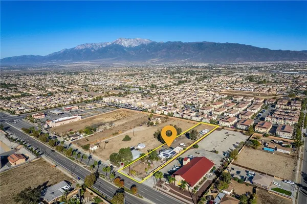 an aerial view of multiple houses with yard