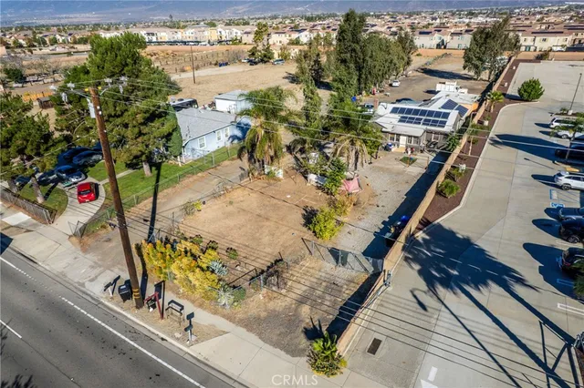 an aerial view of a house with swimming pool and outdoor seating