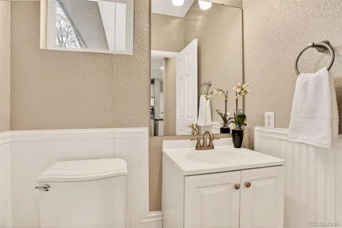 a bathroom with a sink a toilet and mirror