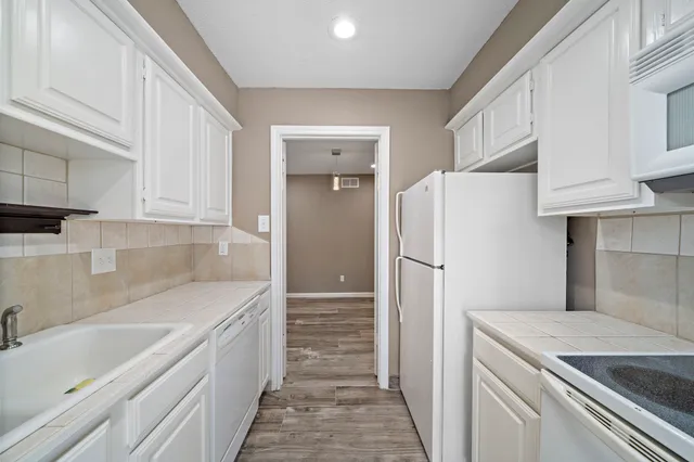 a kitchen with a refrigerator and a sink