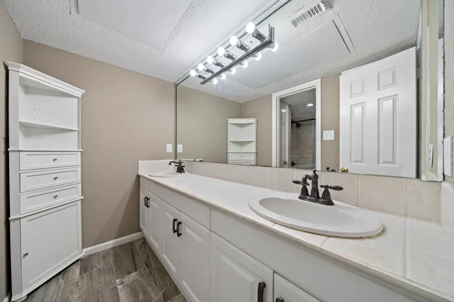 a bathroom with a sink double vanity and a mirror