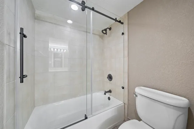 a bathroom with a toilet and a bathtub