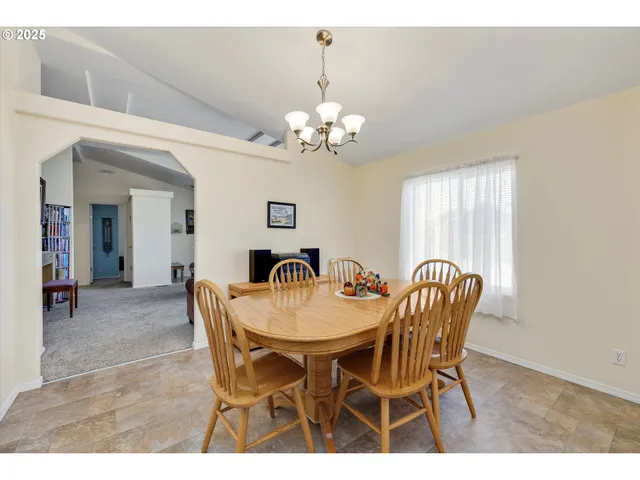 a view of a dining room with furniture and chandelier