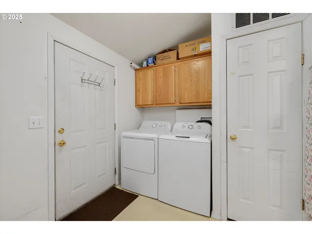a utility room with closet dryer and washer