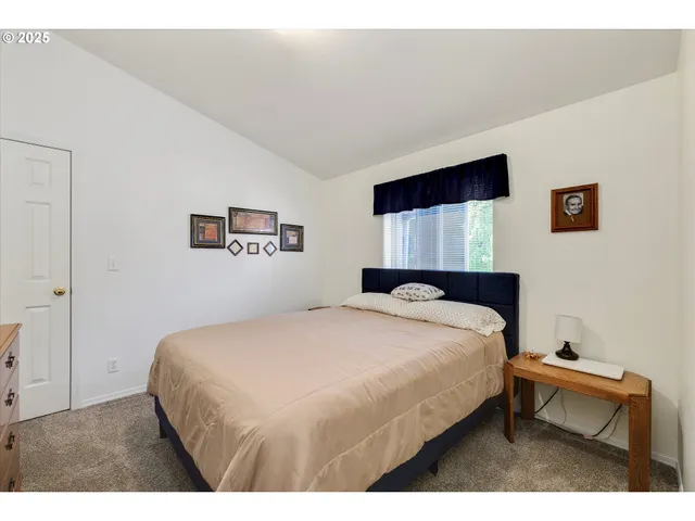 a bedroom with a bed a desk and chair