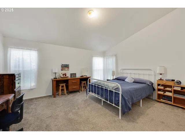a bedroom with furniture and a flat screen tv