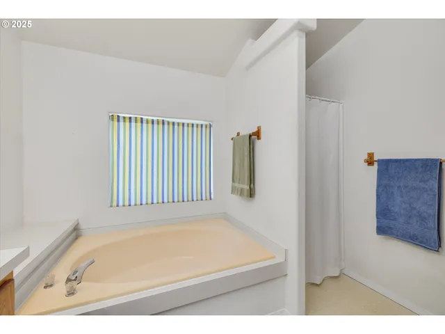 a bathroom with a tub and a window