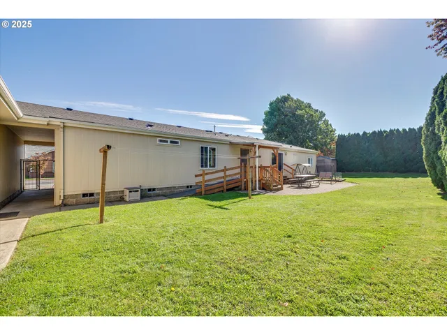 a backyard of a house with table and chairs