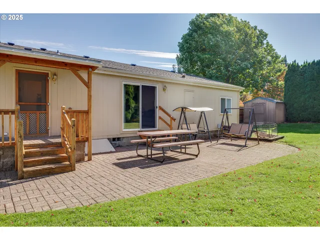 a view of a patio with table and chairs with wooden floor and fence