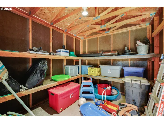 a utility room with stainless steel appliances kitchen island granite countertop a sink and cabinets