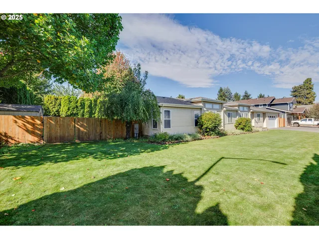 a view of an house with backyard space and garden
