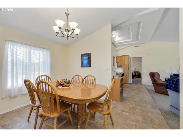 a dining room with furniture and chandelier
