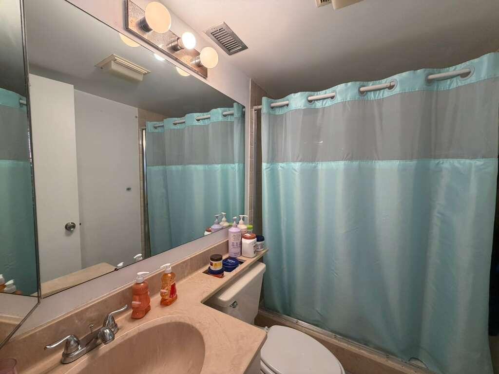 8182 Thames Boulevard, Unit D Boca Raton, FL 33433 - Photo 15 of 20 a bathroom with a sink mirror vanity and toilet