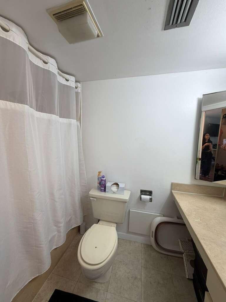 8182 Thames Boulevard, Unit D Boca Raton, FL 33433 - Photo 18 of 20 a white toilet sitting next to a bathroom sink