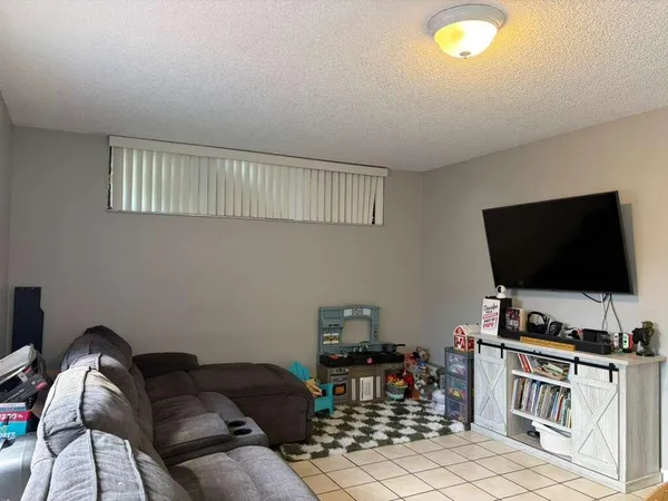 a kitchen with stainless steel appliances kitchen island granite countertop a stove a sink a dining table and chairs