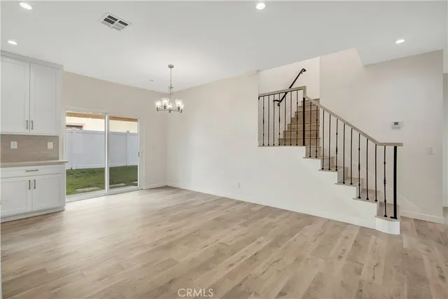 a view of a kitchen with a sink and dishwasher wooden floor
