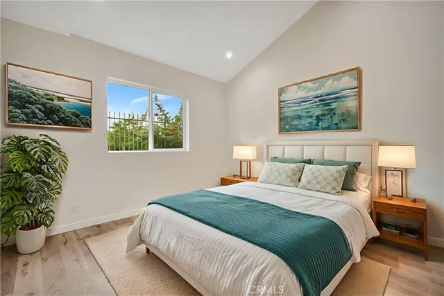 a bedroom with bed and a potted plant